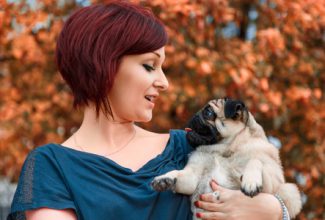 Woman speaking canine to pug