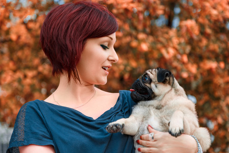Woman speaking canine to pug
