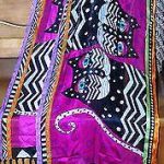 Laurel Burch silk scarf with black cats on a purple ground.