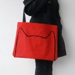 Large, red tote bag with cat's ears outlined and black straps