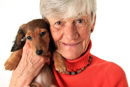 Senior woman holding small dog